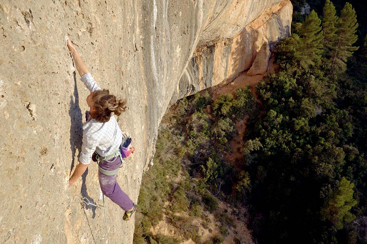 Female climber redpoint leading on limestone (rope diameter)
